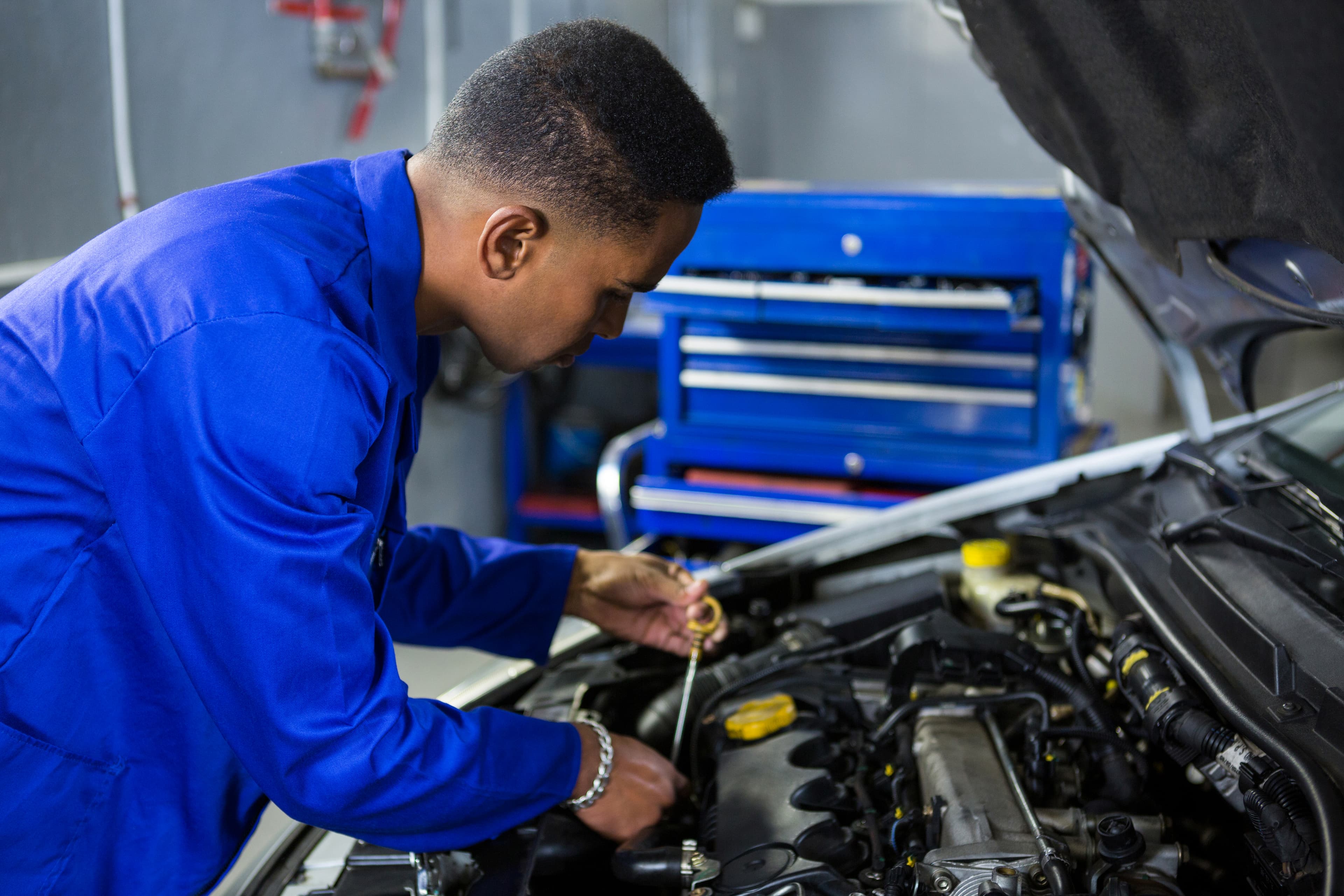 Technician inspecting a vehicle in the workshop